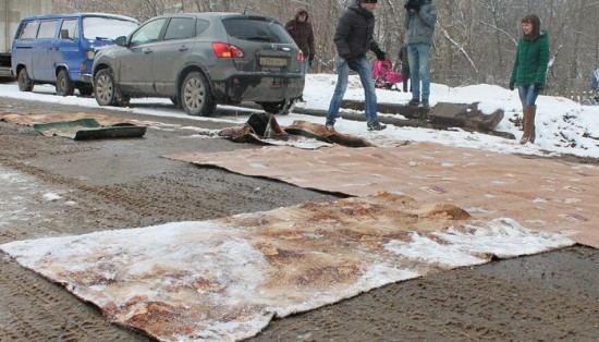 В Нововятске ямы на дороге застелили старыми коврами